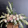 White and pink rose arrangement with a clear cross centerpiece