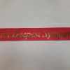 Red ribbon with gold "With Deepest Sympathy" text