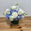 An elegant arrangement of white and blue flowers, artfully designed with premium