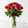 Red roses arranged in a clear glass vase