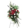 Standing floral spray with red and white flowers on an easel