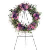 Floral wreath on a metal easel with pink and purple flowers