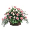 Pink and white flowers arranged in a wicker basket