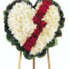 Heart-shaped funeral wreath with white flowers and a red rose diagonal