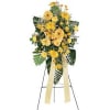 Yellow floral standing spray on an easel with ribbon