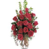 Red roses arranged in a clear glass vase