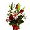 Red roses and pink lilies in a glass vase with a red ribbon