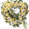 Heart-shaped floral wreath with yellow and white flowers on an easel