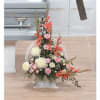 Tall floral arrangement in a clear vase with pink and white blooms