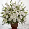 White lilies and roses arranged in a brown vase
