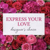 Pink and red roses with orchids around a love message card