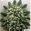 Large white floral standing spray with roses and lilies