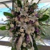 Large white floral standing spray with roses and lilies
