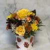 Yellow roses and mixed chrysanthemums in a leaf-patterned box