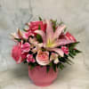 Lush pink lilies and soft blush roses take center stage in this