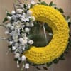 Yellow chrysanthemum wreath with white roses and lilies