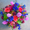 Bright mixed bouquet with coral roses, blue flowers, and pink blooms