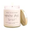 Labeled candle in a glass jar with a gold lid
