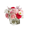 Pink and red roses with white daisies in a clear square vase