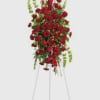 Tall standing spray of red roses on a metal easel