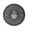 Round slate coaster with a coffee cup graphic and text
