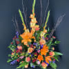 Tall floral arrangement with orange lilies and peach roses