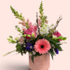 Pink and white mixed bouquet in a blush ceramic vase