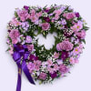 Heart-shaped floral wreath with lavender roses and purple ribbon