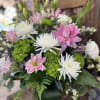 Pink and white floral arrangement with spider mums and lilies