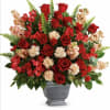 Red roses and red carnations in a gray urn vase