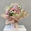 Bouquet of pink and white flowers wrapped in blush paper
