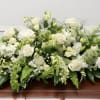 The Peaceful Garden Embrace is an elegant yet comforting tribute that symbolizes