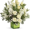 White roses and tulips in a green glass vase