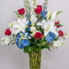 A graceful arrangement of radiant red roses, fragrant white lilies, delicate white