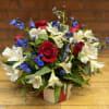 Red roses and white-blue alstroemeria in a wrapped vase arrangement