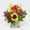 Mixed bouquet with a sunflower, pink rose, and yellow lilies in a wooden box