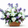 White lilies and white roses take center stage in this airy basket