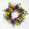 Bright, cheerful sunflowers alternating with rich purple dahlia-like blooms create a high-contrast