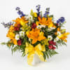 A bright, garden-style sympathy funeral basket that offers comfort with a hopeful