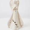 Cream-colored angel figurine with cutout details