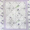 Quilt with purple rose floral print and patchwork center panel