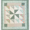 Patchwork quilt with teal, cream, and patterned geometric blocks