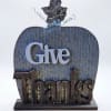 Decorative tabletop sign shaped like a pumpkin with the words Give Thanks