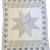 Patchwork quilt with a large star pattern and floral border
