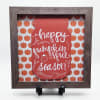 Framed fall sign reading "happy pumpkin spice season" with pumpkin pattern