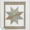 Patchwork quilt with a star pattern in muted floral fabrics