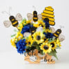 Sunflower arrangement with bee decorations in a printed box