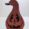 Wooden jack-o'-lantern decoration with a carved smiling face