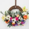 Floral wreath with colorful blooms on a grapevine ring