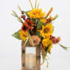 Sunflower arrangement in a wooden lantern with a candle inside